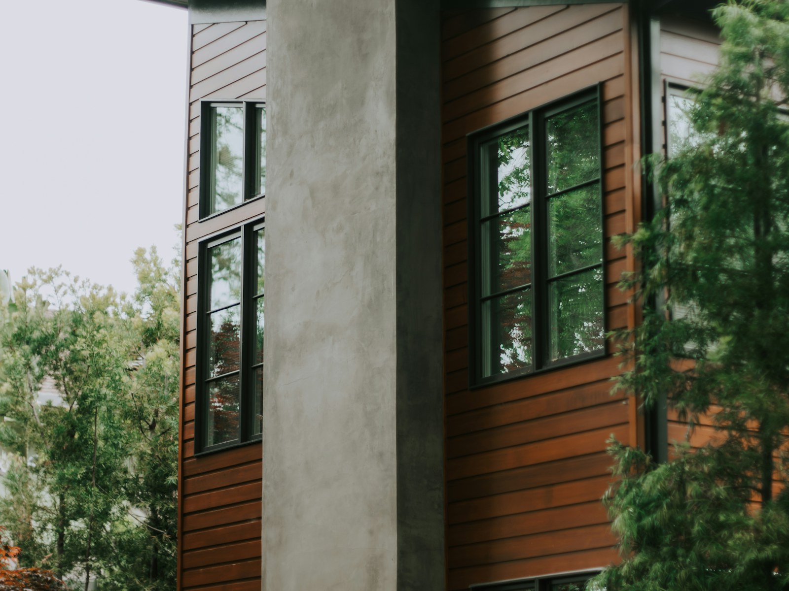 Illustrative modern home with warm wood siding and large windows