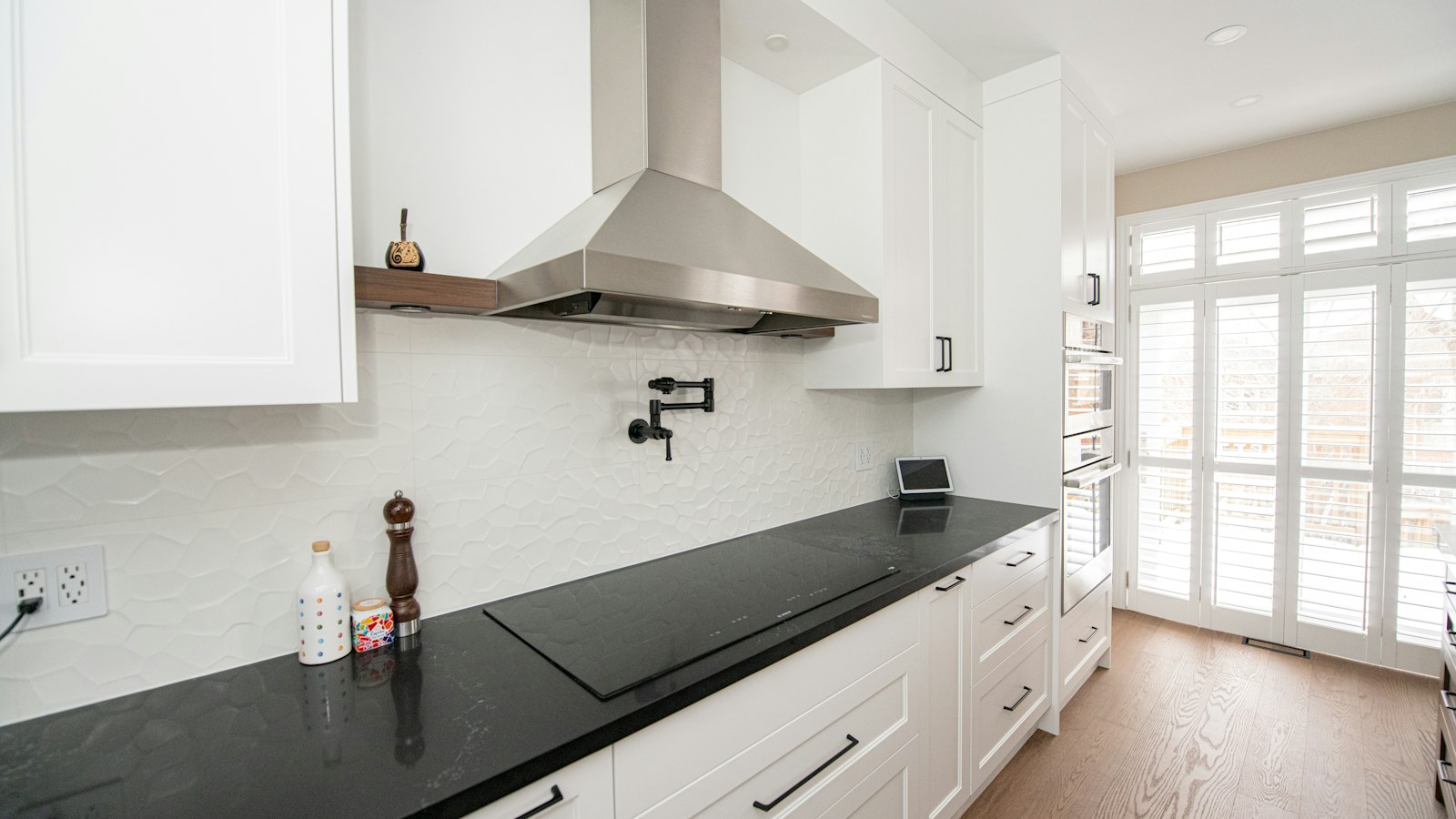 Illustrative photo of a finished white kitchen with a dark counter