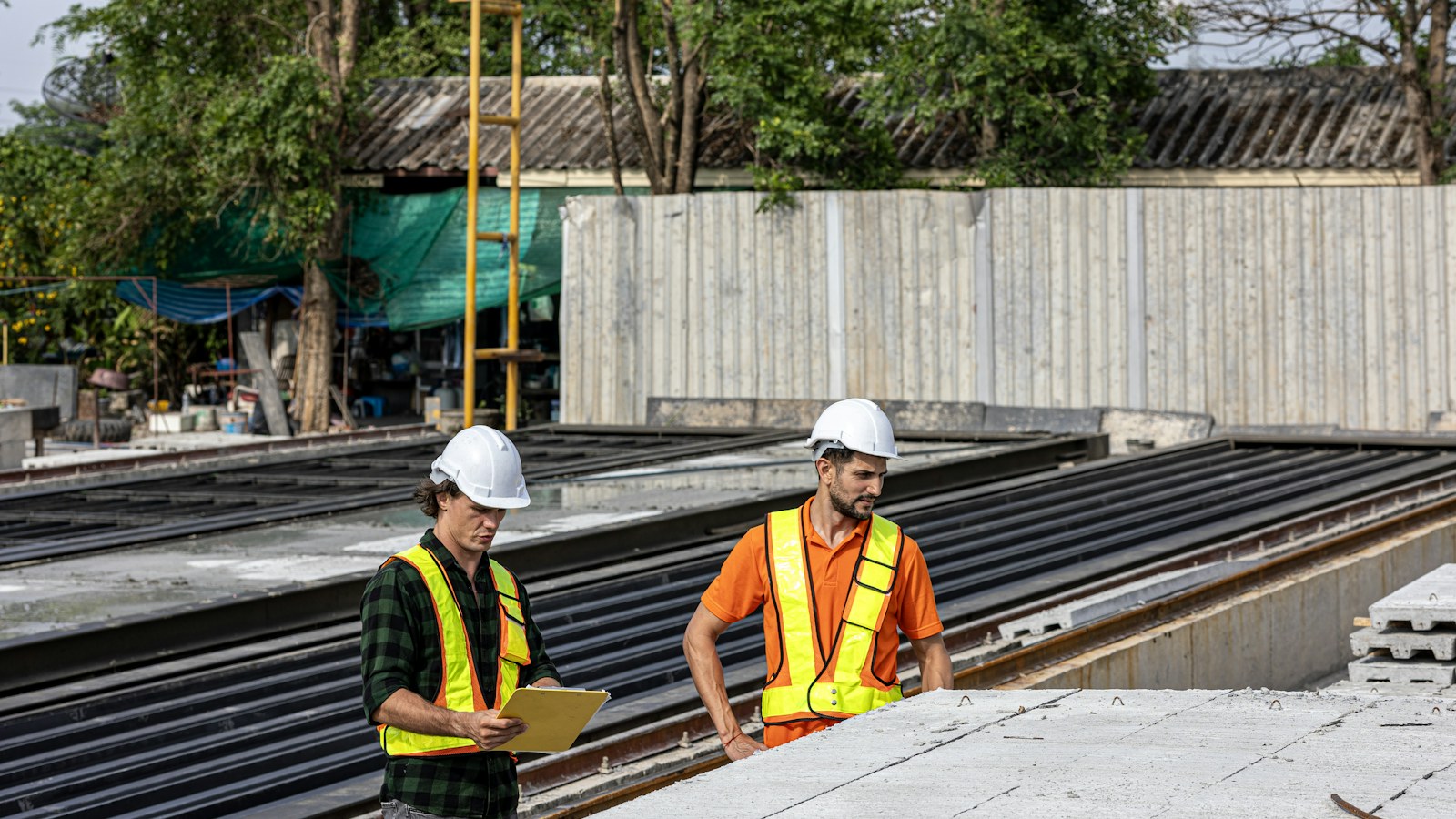 Illustrative photo of construction workers discussing a building project